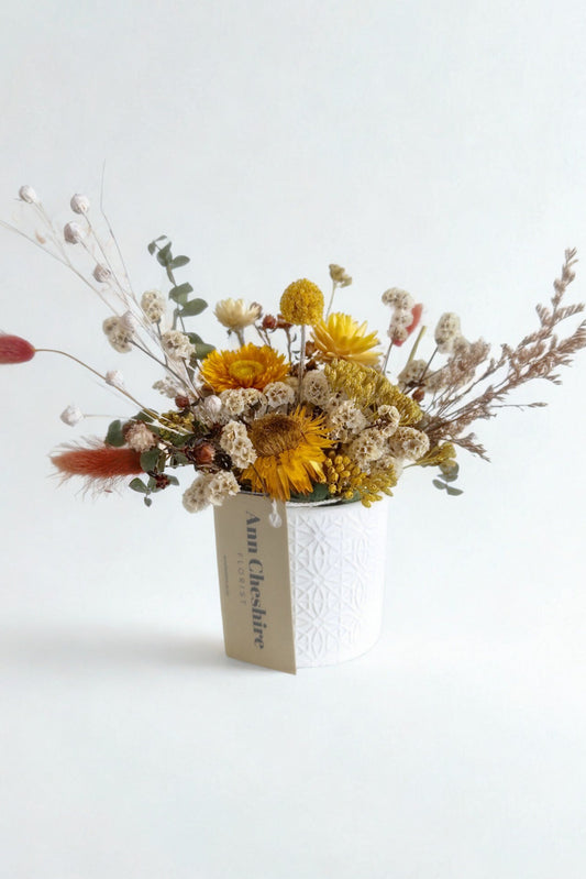 Bouquet of dried flowers with a tag on a white background