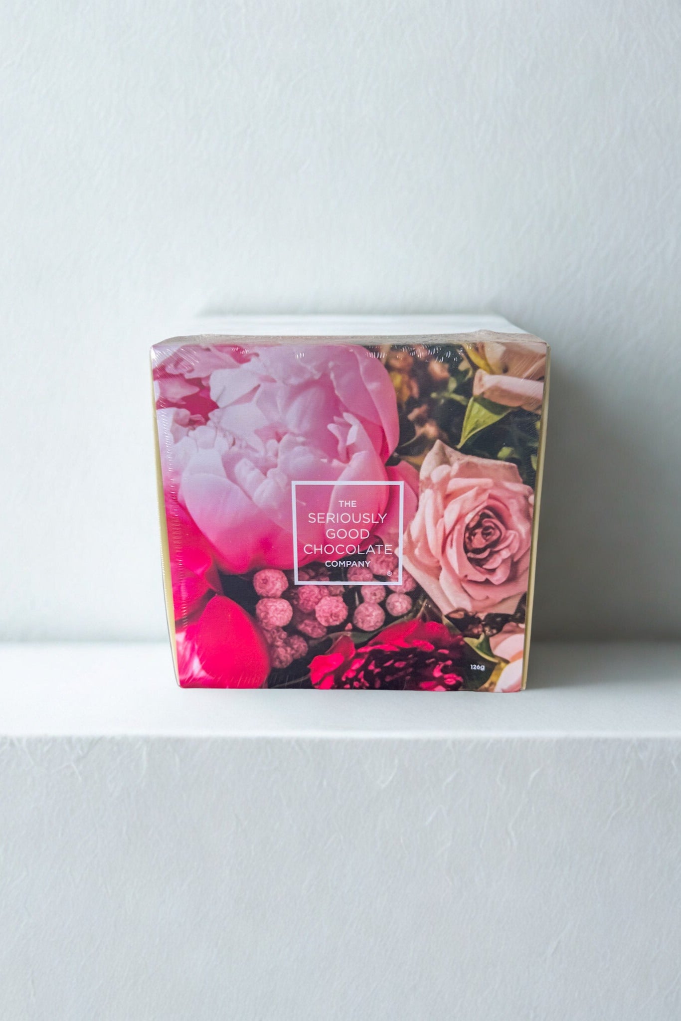 Chocolate box with floral design on a white surface