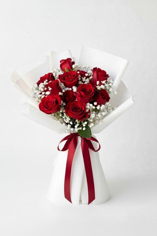 Bouquet of red roses with a red ribbon on a white background