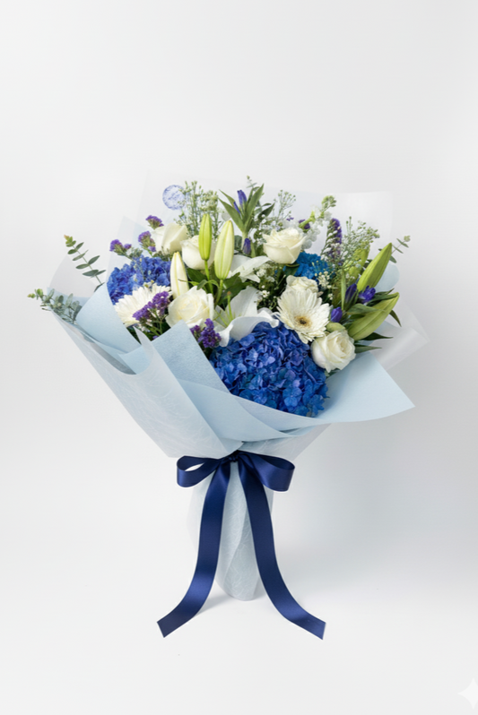 Bouquet of flowers with blue ribbon on a white background