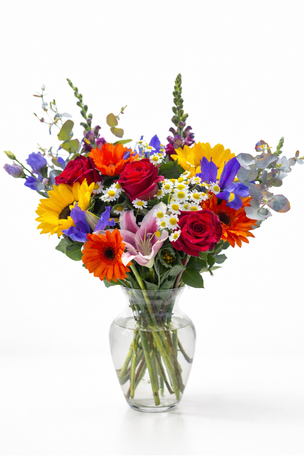 Colorful bouquet of flowers in a clear vase on a white background
