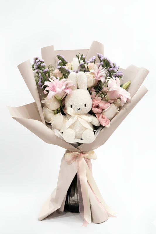 Bouquet with a plush toy rabbit and flowers on a white background