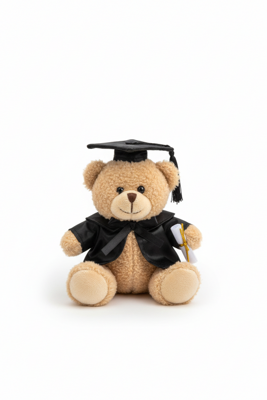 Teddy bear wearing a graduation cap and gown on a white background