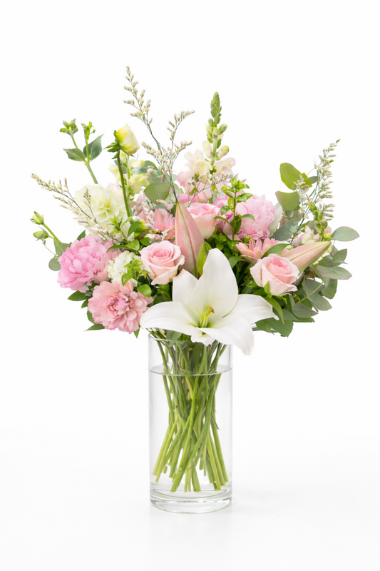 Bouquet of flowers in a clear vase on a white background