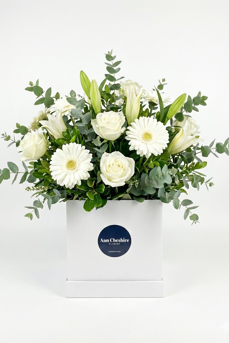 Bouquet of white flowers in a box with a visible brand label on a white background