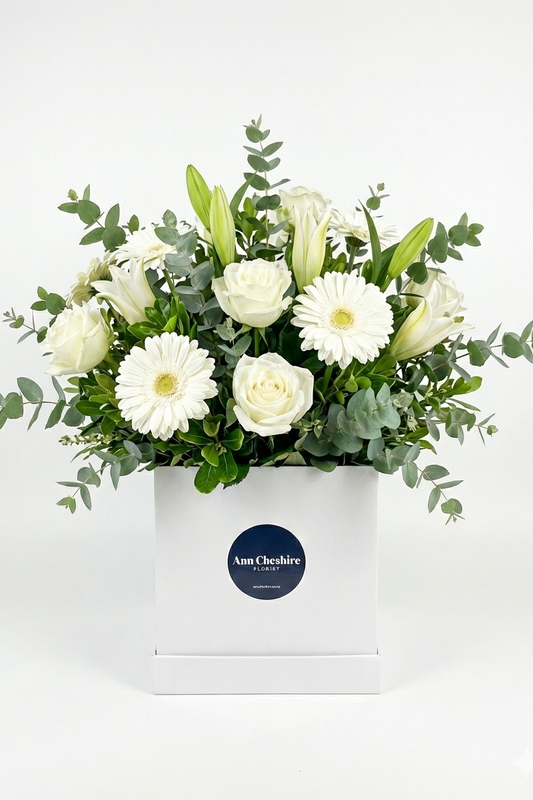 Bouquet of white flowers in a box with a visible brand label on a white background