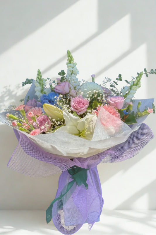 Bouquet of flowers with a purple ribbon on a white background