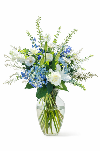 Bouquet of flowers in a clear vase on a white background