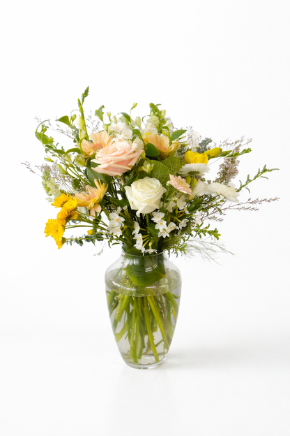 Bouquet of flowers in a clear vase on a white background