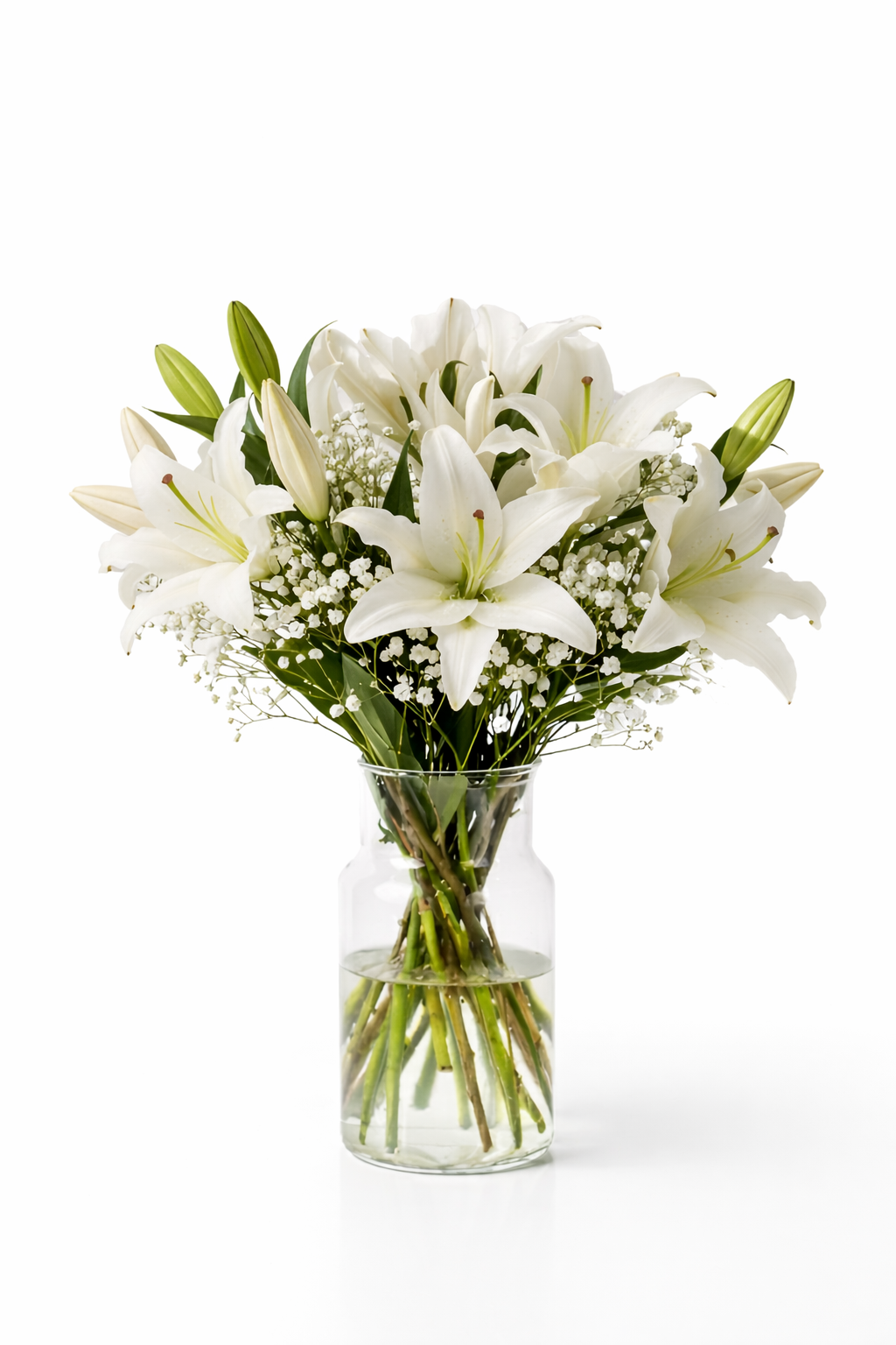 Bouquet of white lilies in a clear vase on a white background