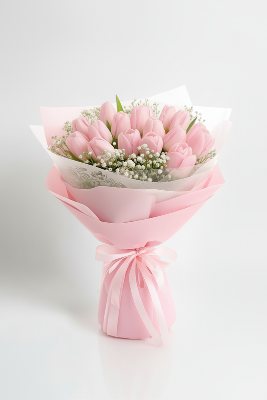 Bouquet of pink tulips wrapped in pink paper on a white background